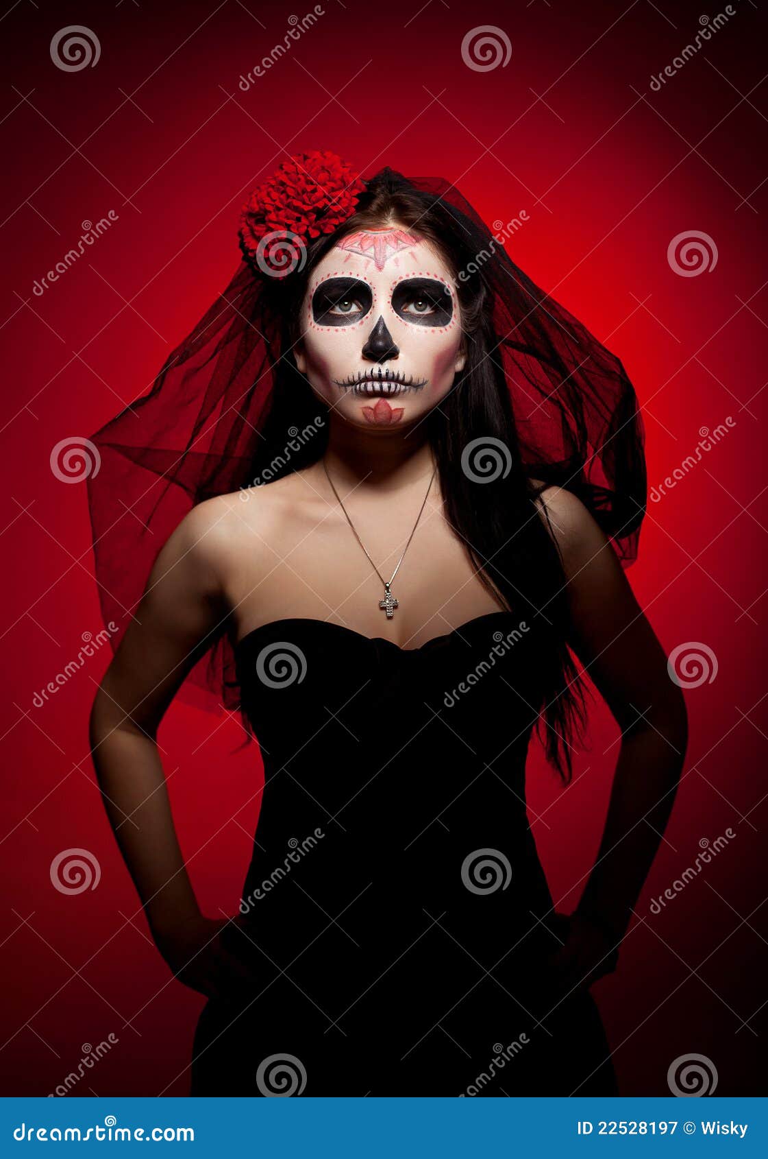 Serious woman in day of the dead mask on red. Young woman wearing with roses dressed up for All Souls Day