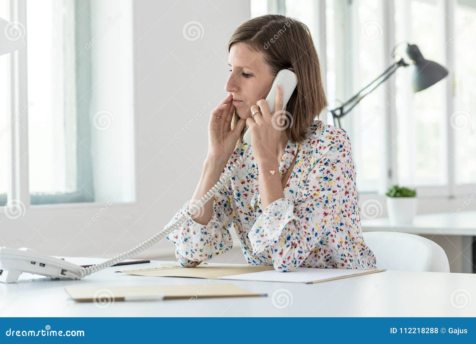 Serious Young Business Woman Making a Phone Call Stock Photo - Image of