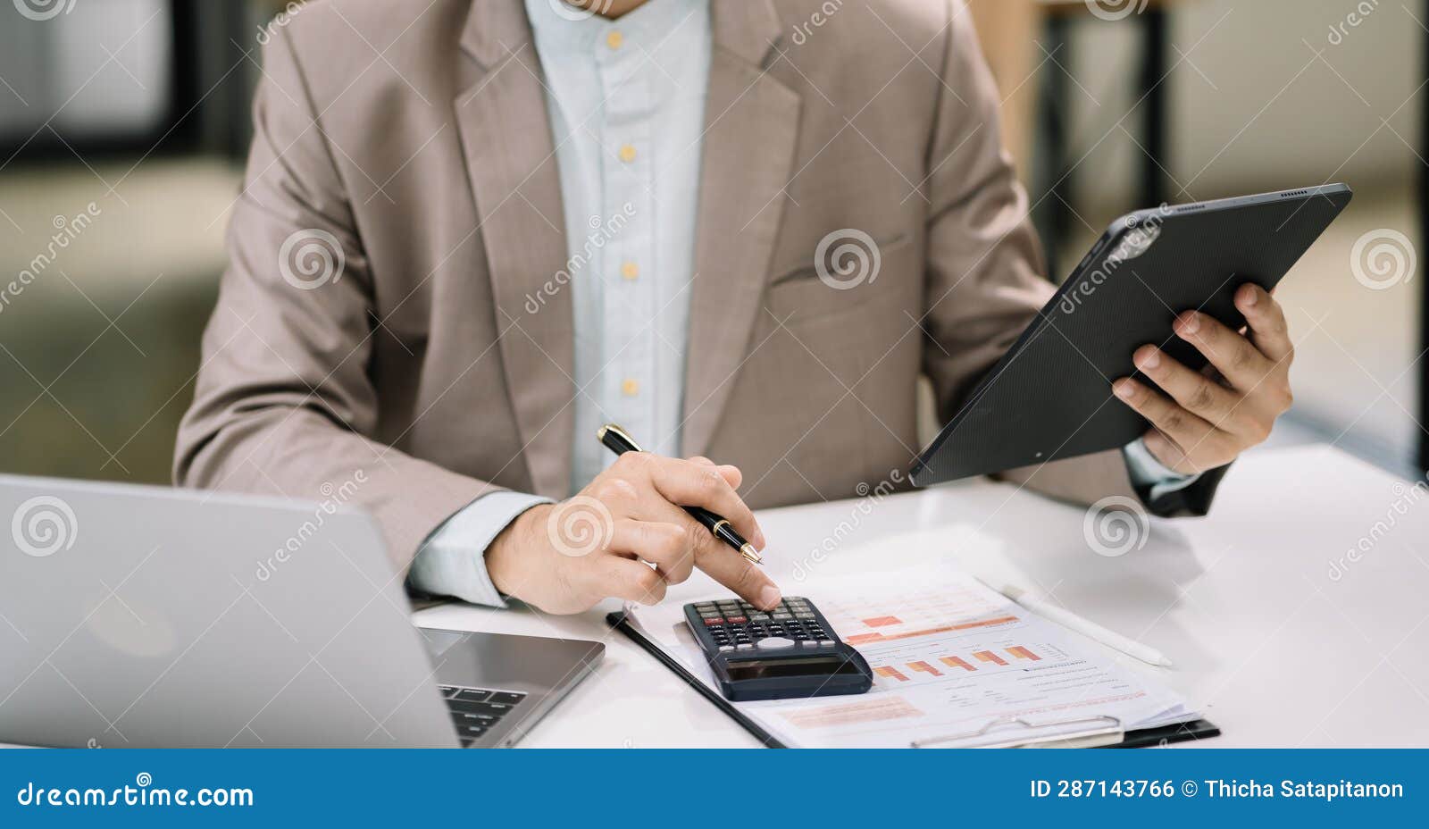 serious young man sit at workplace desk in office use calculator calculates monthly expenses, taxes, personal budget management