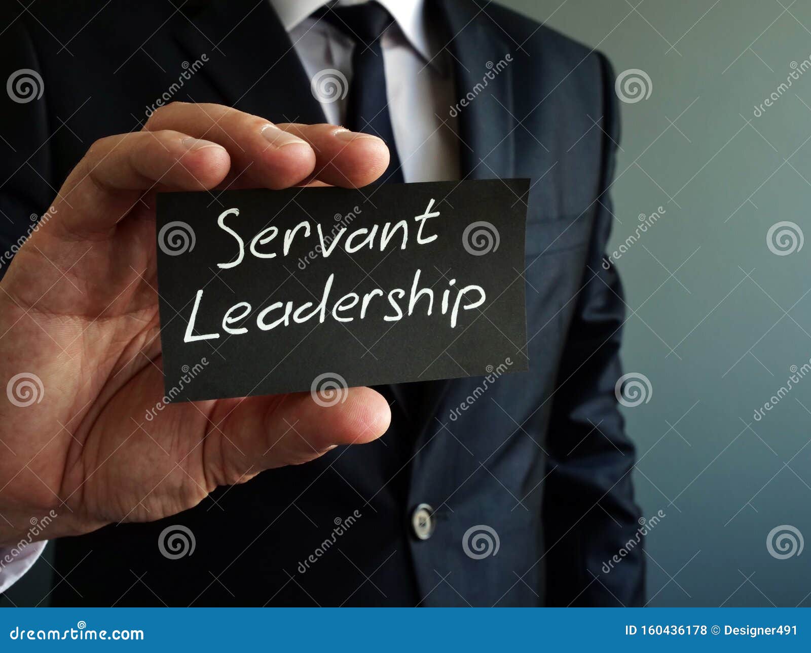servant leadership concept. black piece of paper in the hand