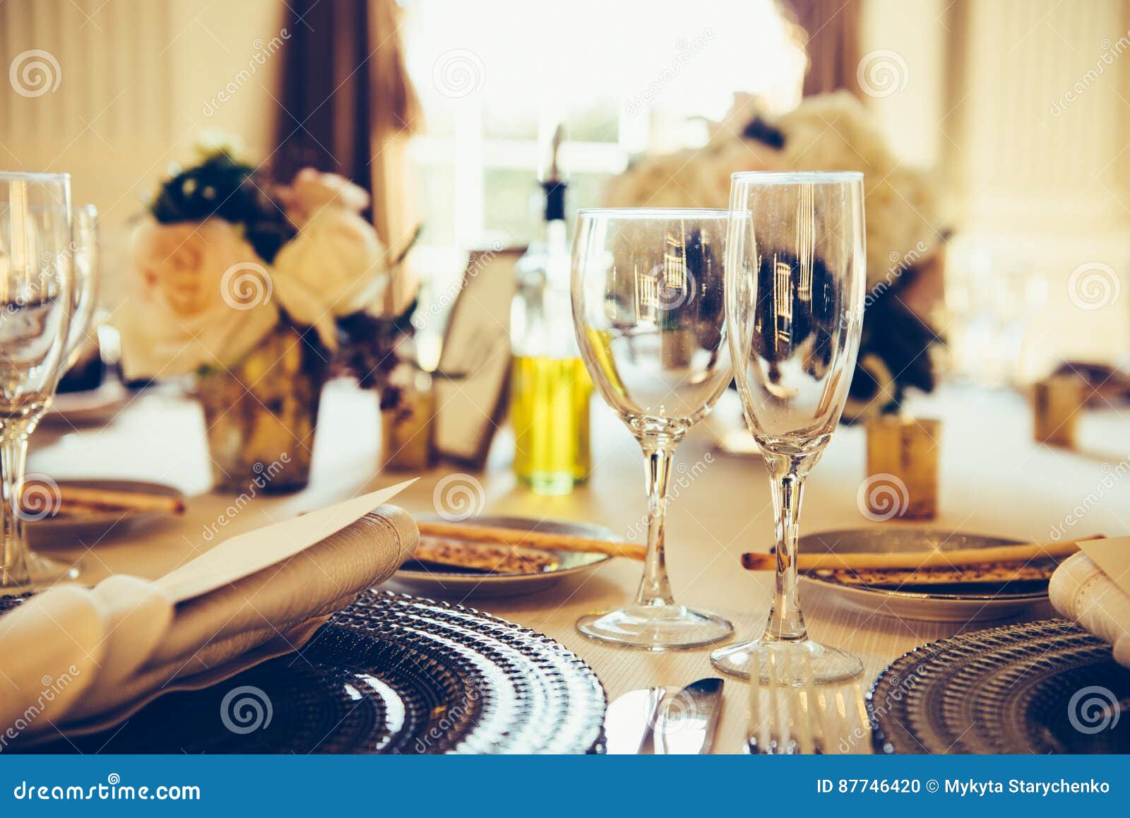 Served Table for the Event. White Tablecloth and Restaurant Cutlery