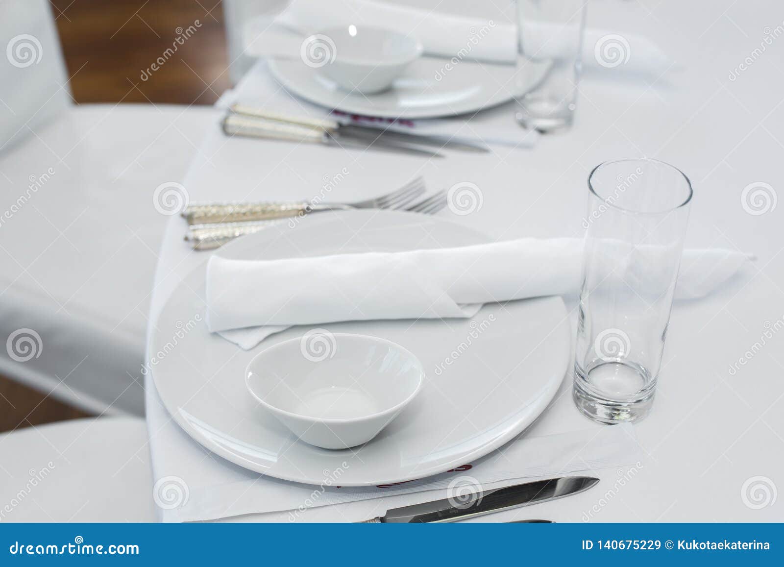 Served Table in the Restaurant. Clean White Dishes Layout on a White