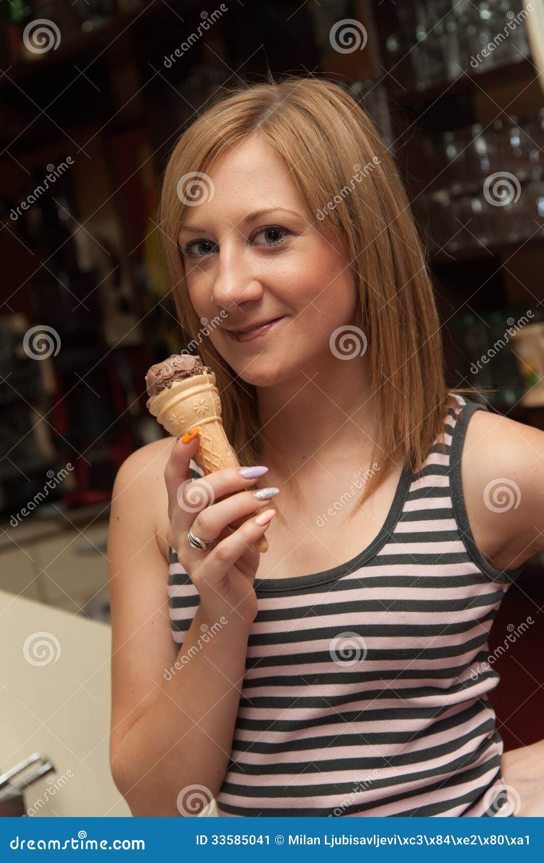 Serveerster Eating Icecream. Jong meisje die als serveerster werken die roomijs in een koffie eten