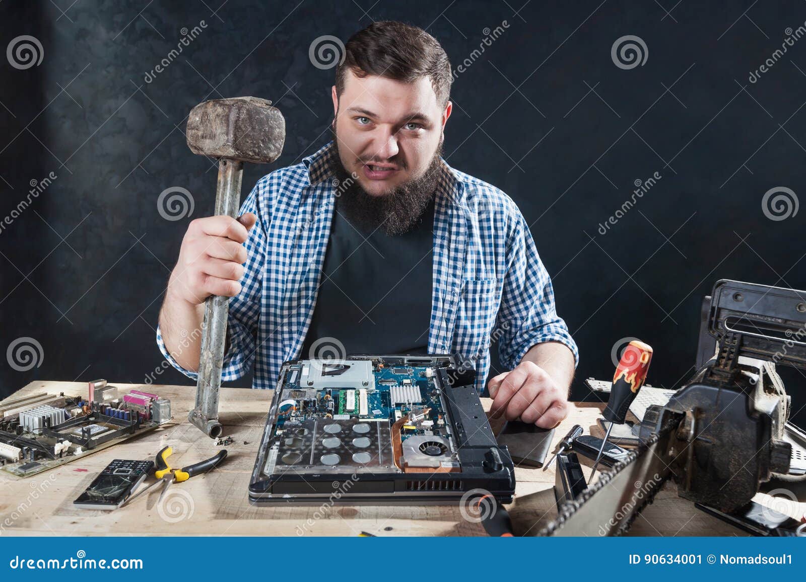 Service Engineer with Hammer, Laptop on the Desk Stock Image Image of