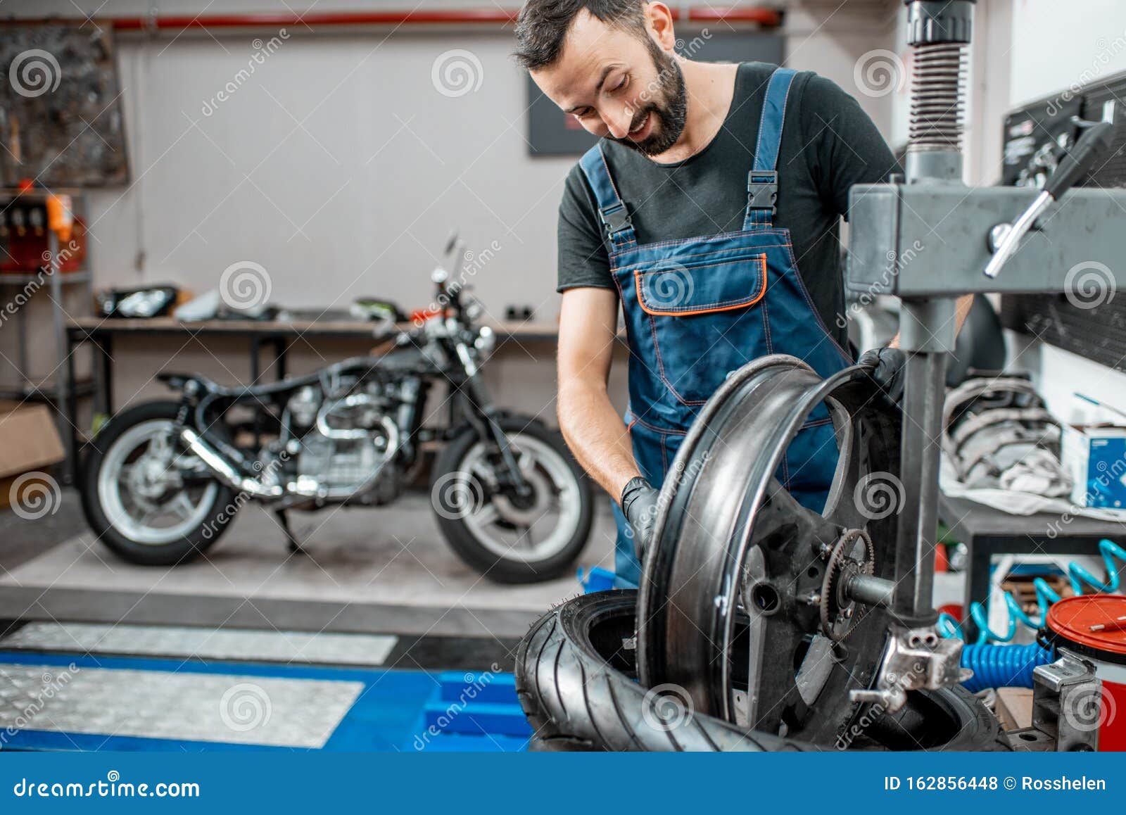 Worker Changing a Motorcycle Tire Stock Photo - Image of professional