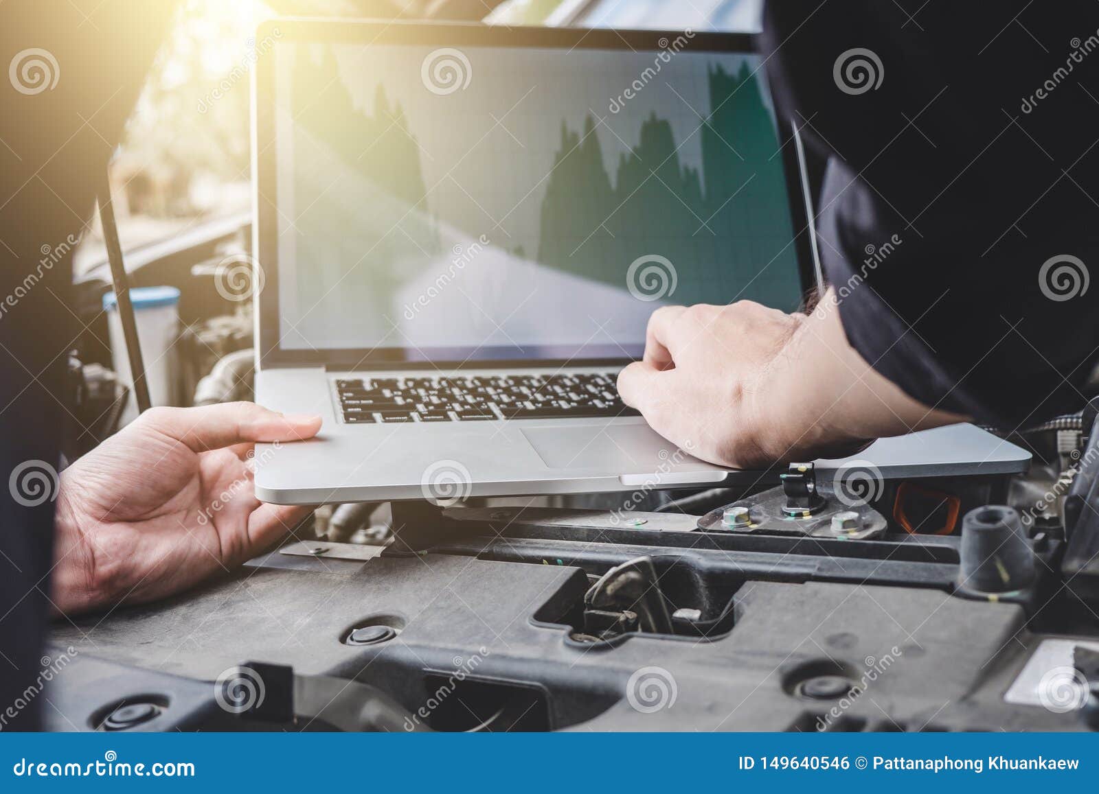 services car engine machine concept, automobile mechanic repairman checking a car engine with using computer diagnostics while