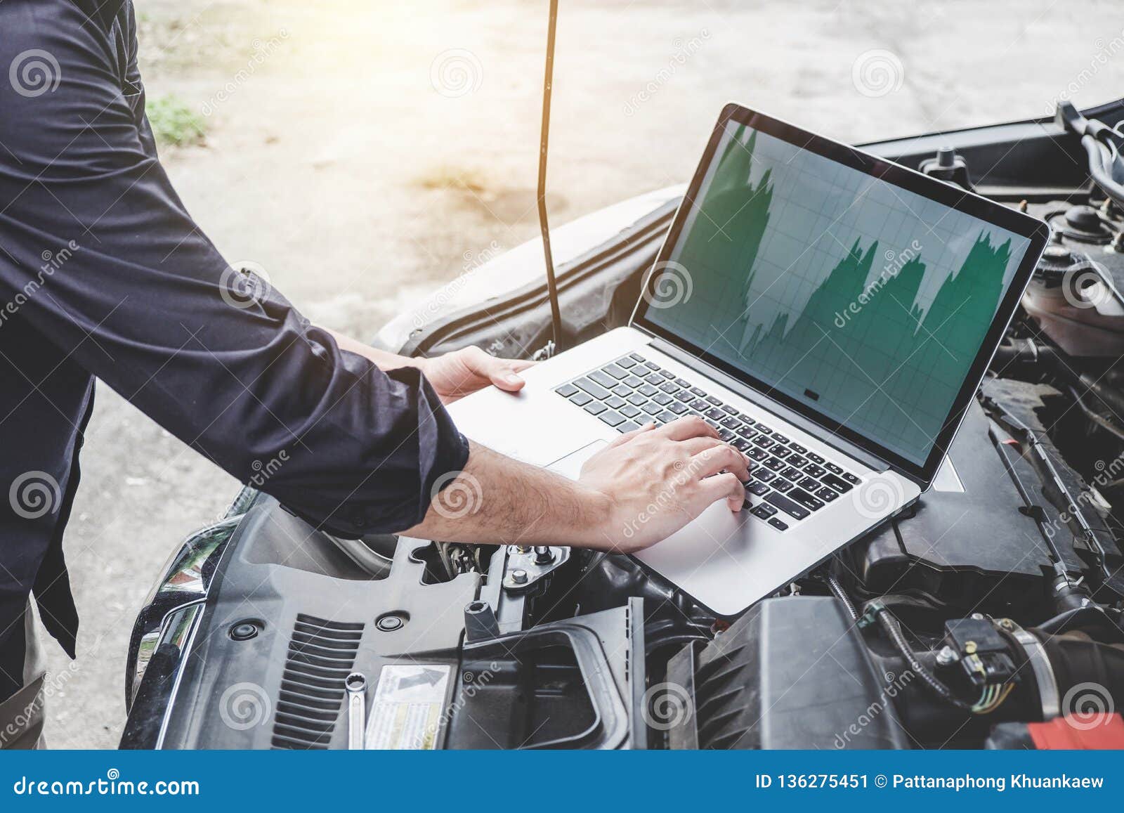 services car engine machine concept, automobile mechanic repairman checking a car engine with using computer diagnostics while