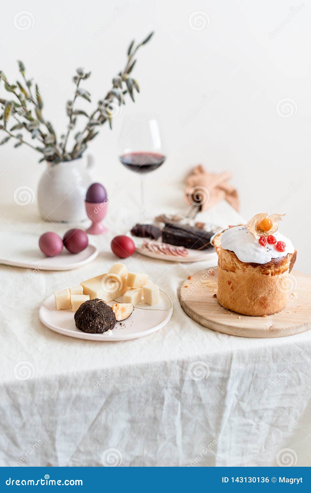 Serving Easter Table with Tasty Dishes and Glass of Wine Stock Photo