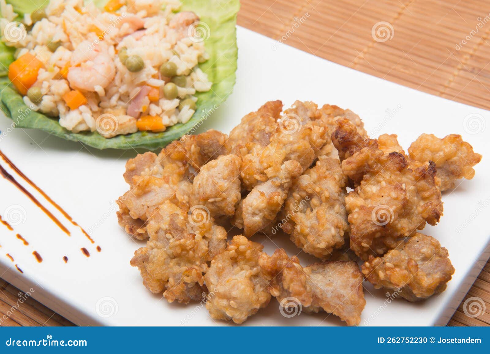 sesame chicken dish and chopsticks on bamboo placemat
