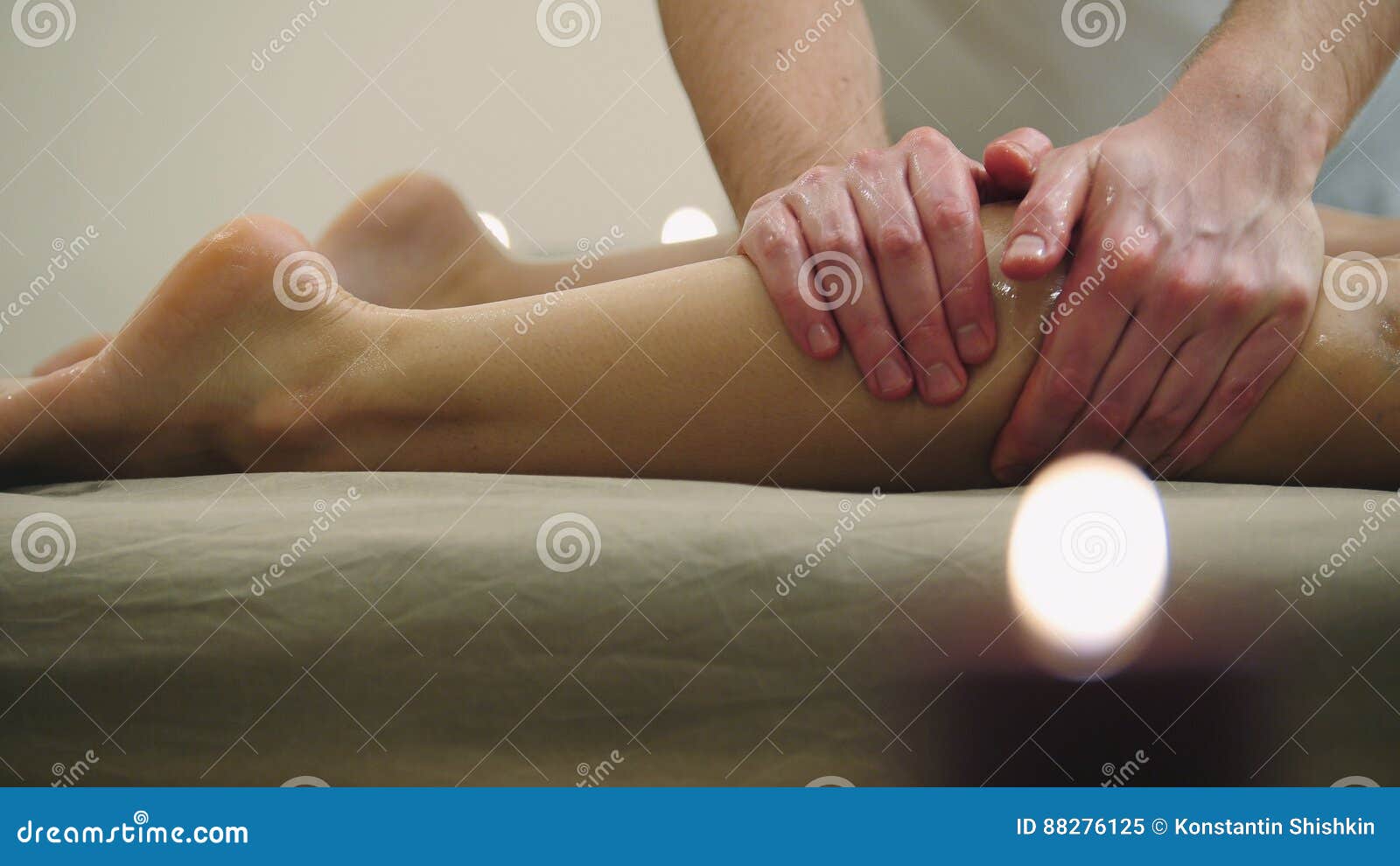 sesame oil massage for calf muscle. relaxation treatment for young female, close up