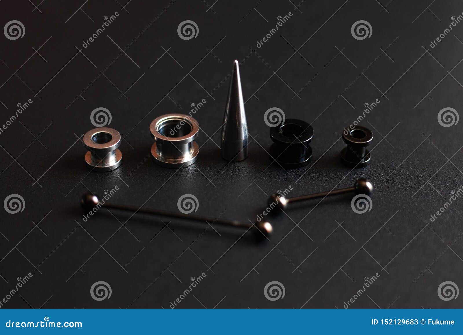 Set of Accessories for Piercing on a Dark Background Stock Image