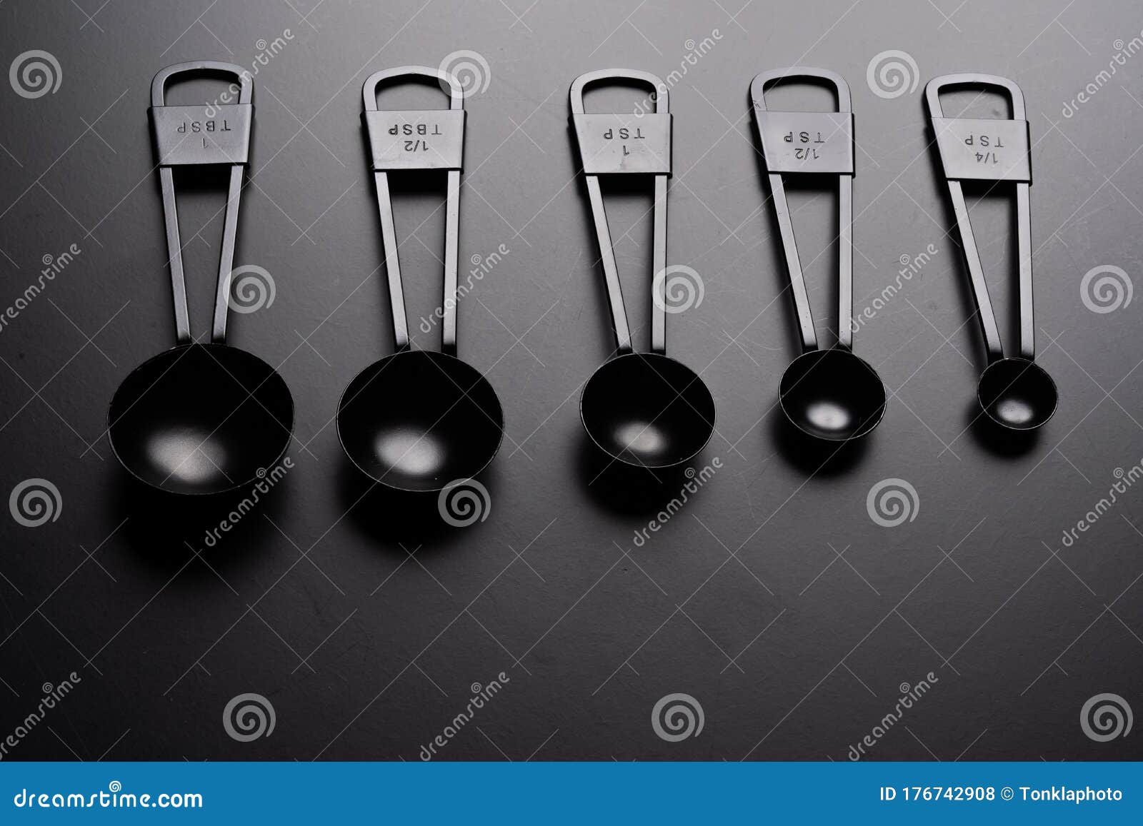 A Set of Black Measuring Spoon on Black Background Stock Photo - Image of  group, kitchenware: 176742908