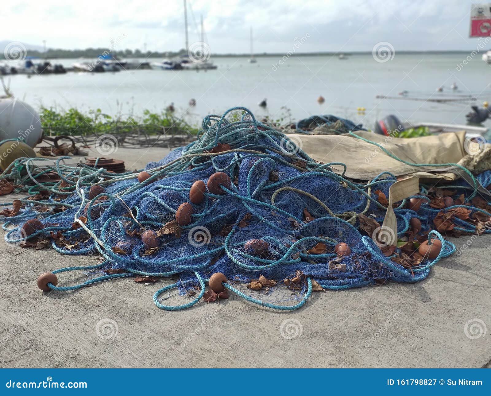 https://thumbs.dreamstime.com/z/set-blue-fishing-nets-ropes-pier-port-caribbean-village-turquoise-calm-waters-boats-moored-background-pie-161798827.jpg