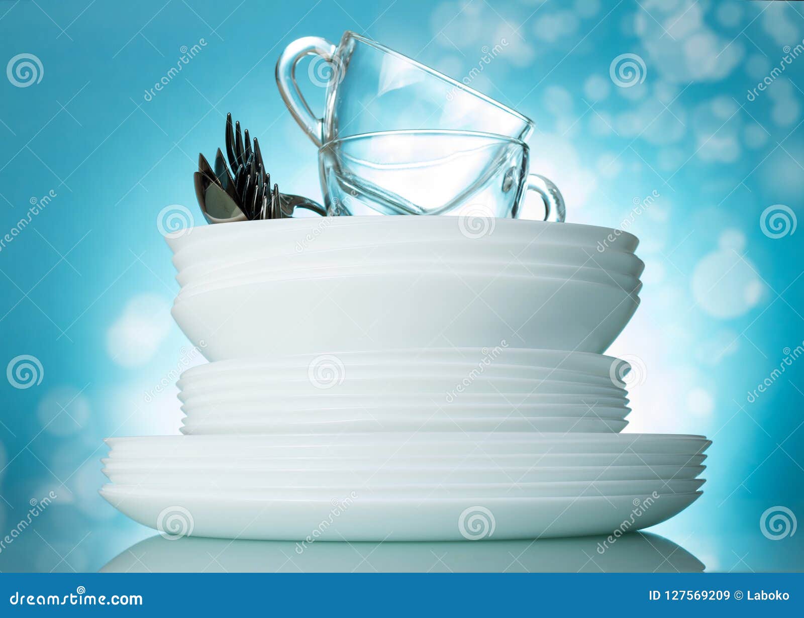 Set Clean Washed Dishes and Cups in Beautiful Bright Blue Background