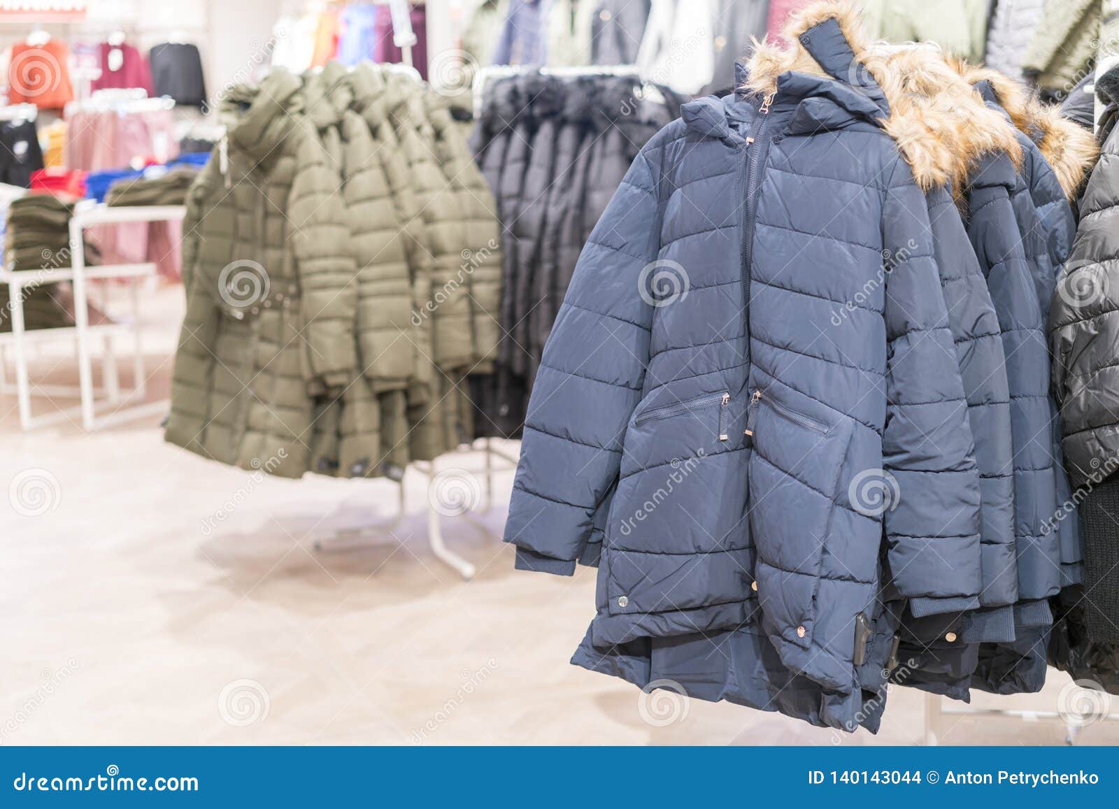 Set Of Clothes, Coat On The Rack Clothing Shop Interior On Background ...