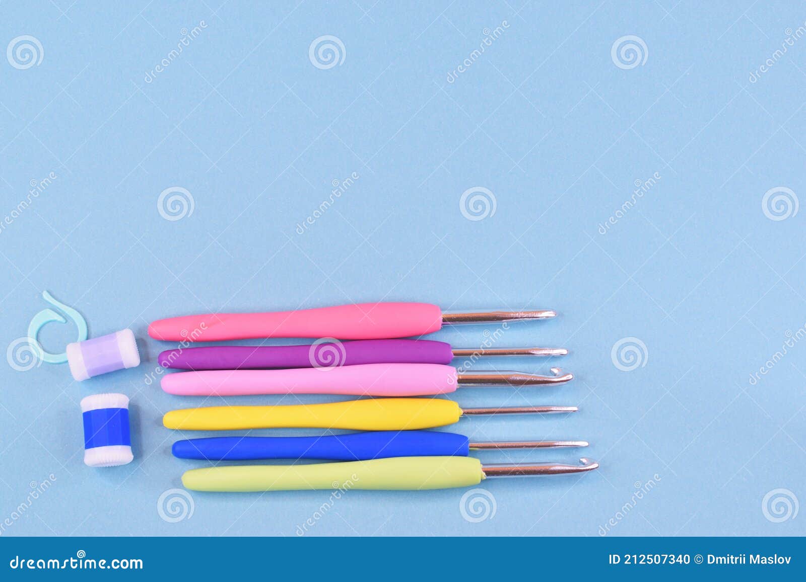 A Set of Colored Crochet Hooks Laid Out Next To the Row Counters. Stock Photo Image of