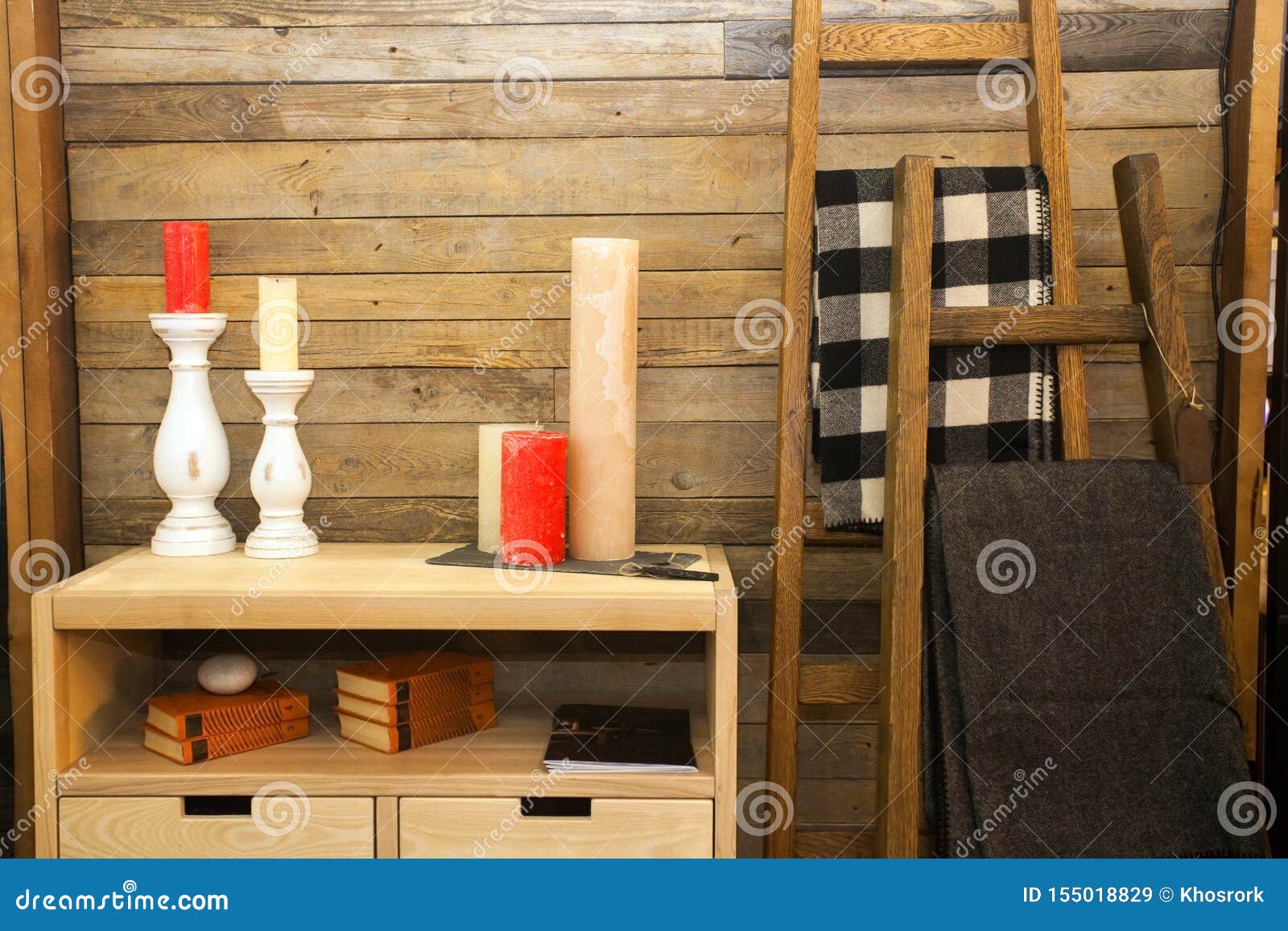 Set Of Colorful Candles On Wooden Chest Of Drawers Near Wall At