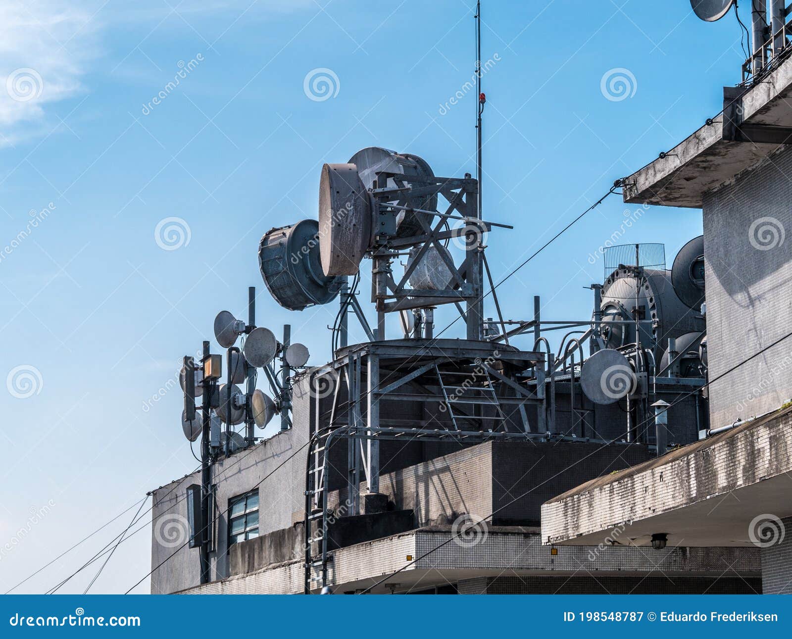 Set of Communication Antennas on a Building Rooftop Editorial
