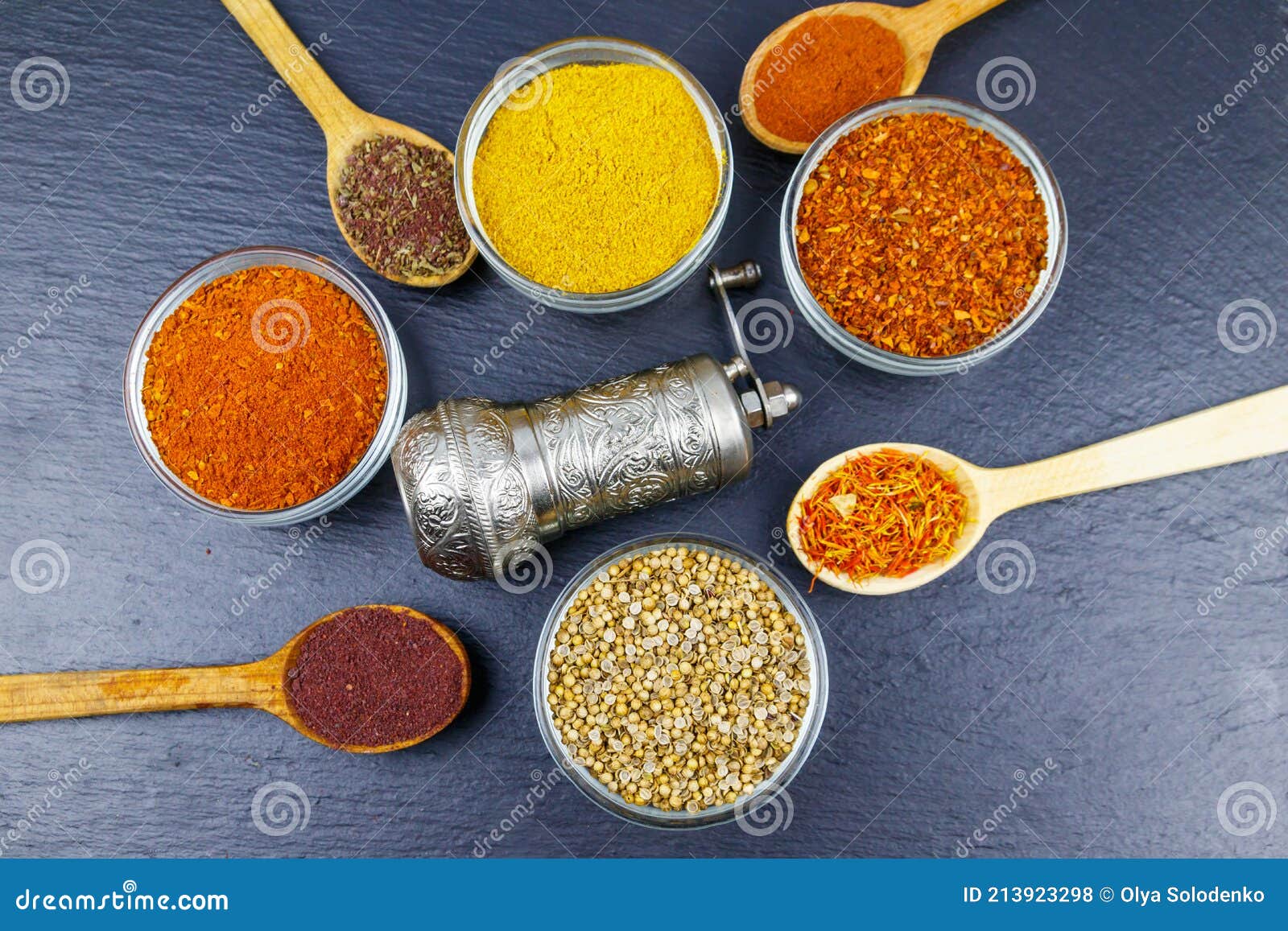 Set of Different Aromatic Spices and Spice Mill on Black Slate. Top