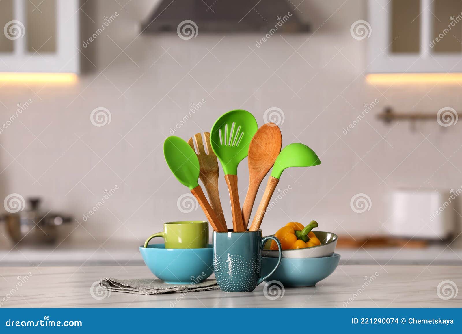 Set of Different Cooking Utensils and Ceramic Dishes on White Table in