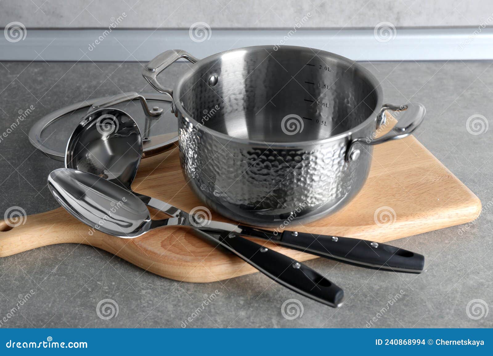 Set of Different Cooking Utensils on Grey Countertop in Kitchen Stock