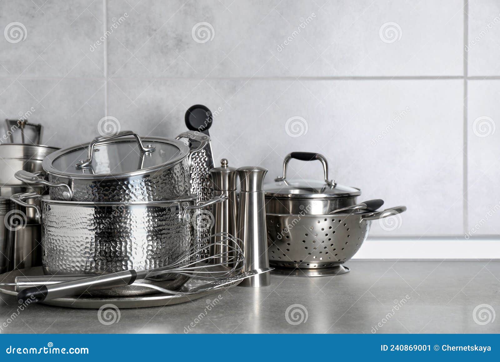 Set of Different Cooking Utensils on Grey Countertop in Kitchen Stock