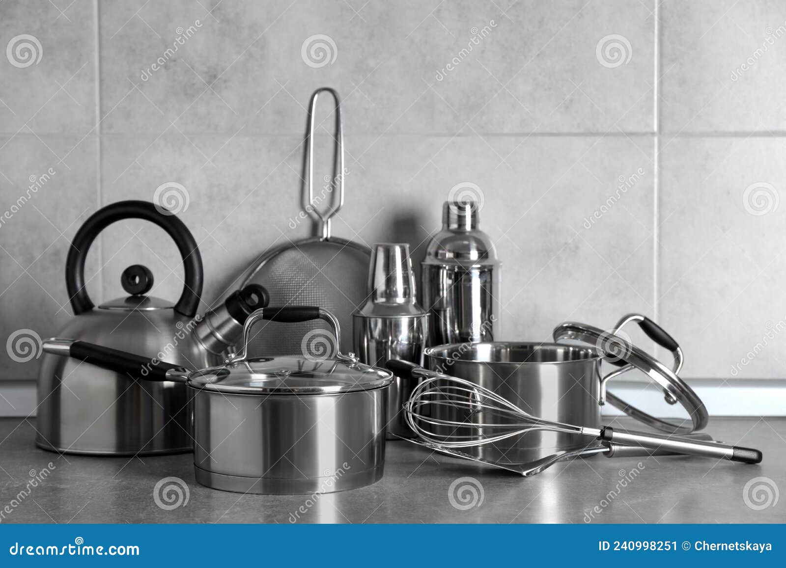 Set of Different Cooking Utensils on Grey Countertop in Kitchen Stock
