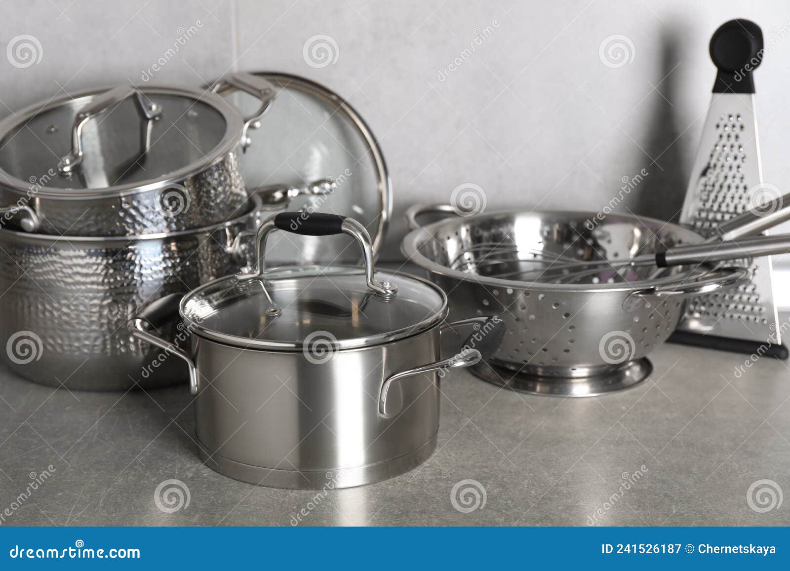 Set of Different Cooking Utensils on Grey Countertop in Kitchen Stock