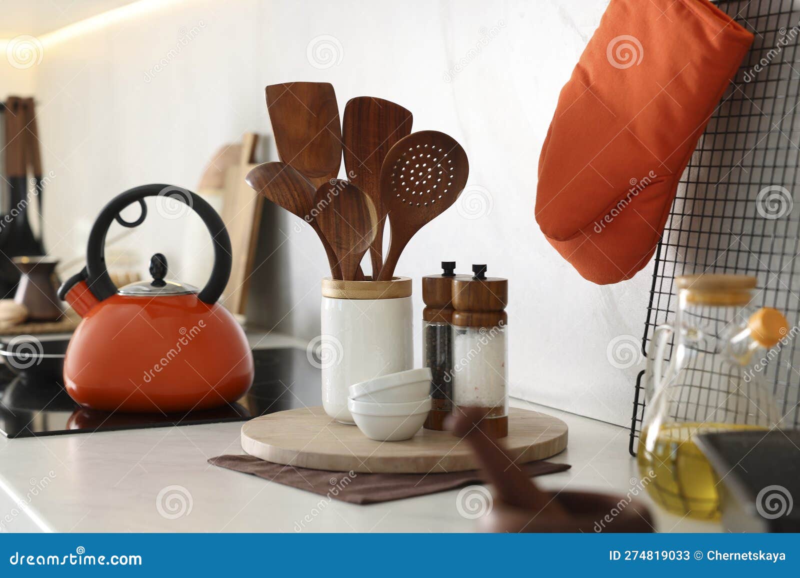 Set of Different Utensils and Dishes on Countertop in Kitchen Stock