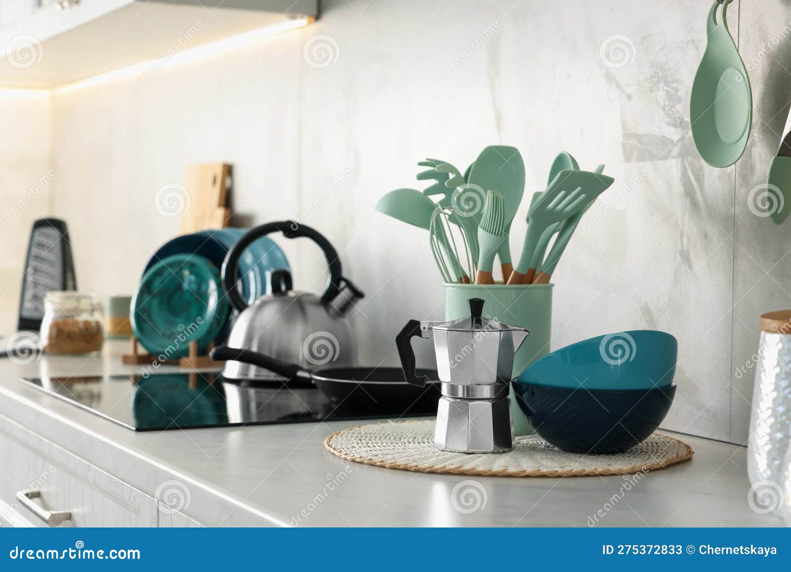 Set of Different Utensils and Dishes on Countertop in Kitchen Stock