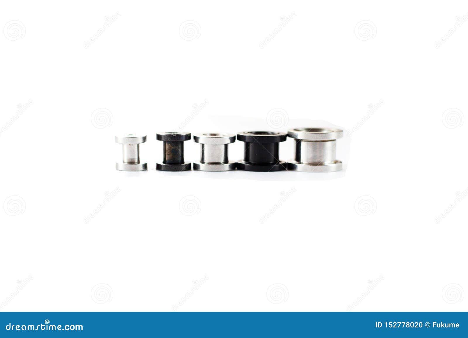 A Set of Ear Tunnels of Different Sizes, Black and Chrome Color on a