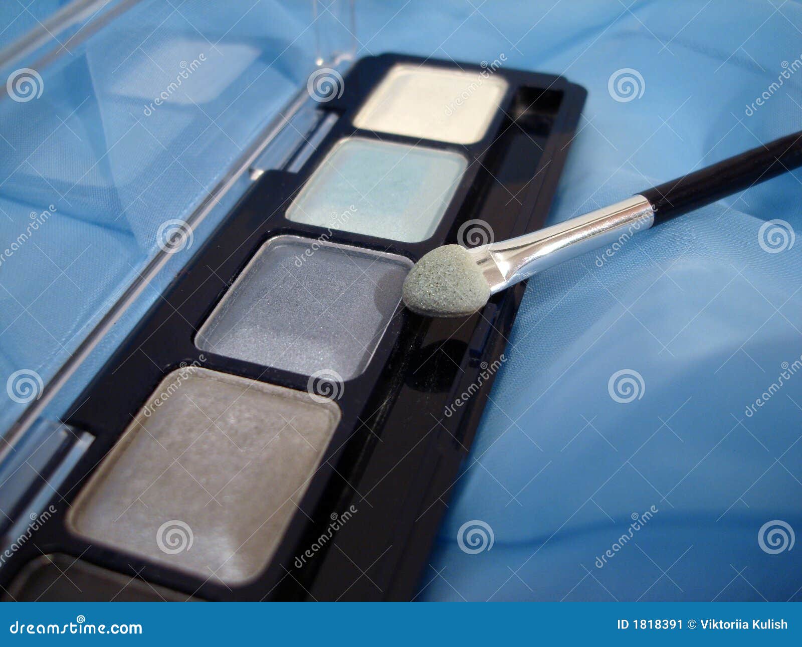 Set of Eyeshadows and Applicator Brush on Blue Stock Image Image of