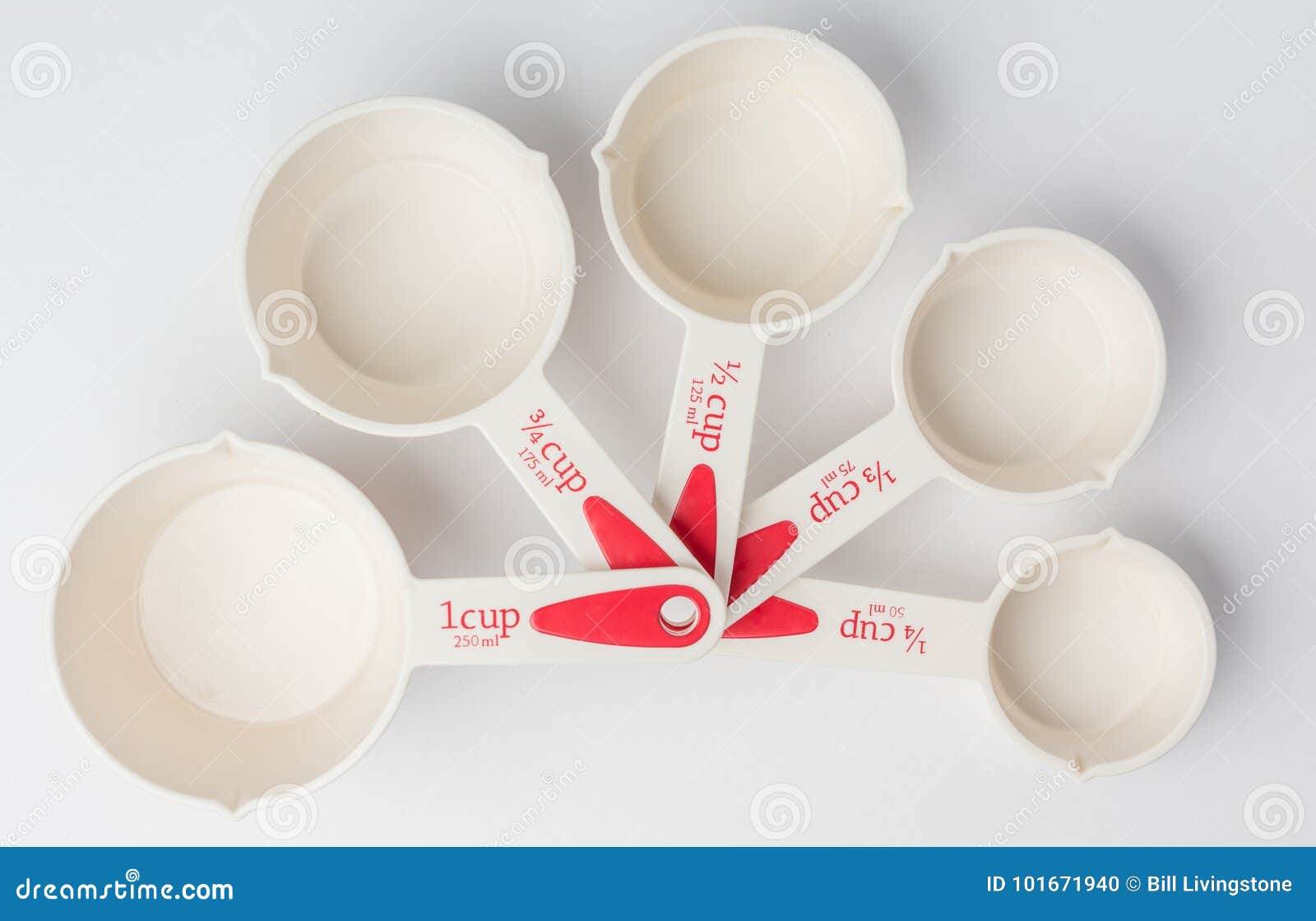 Set of Fanned Measuring Cups on White Background Top View Stock Photo