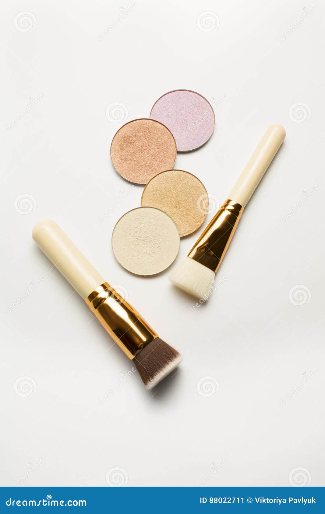 Set of Highlighters with Cosmetic Brushes Over a White Background Stock