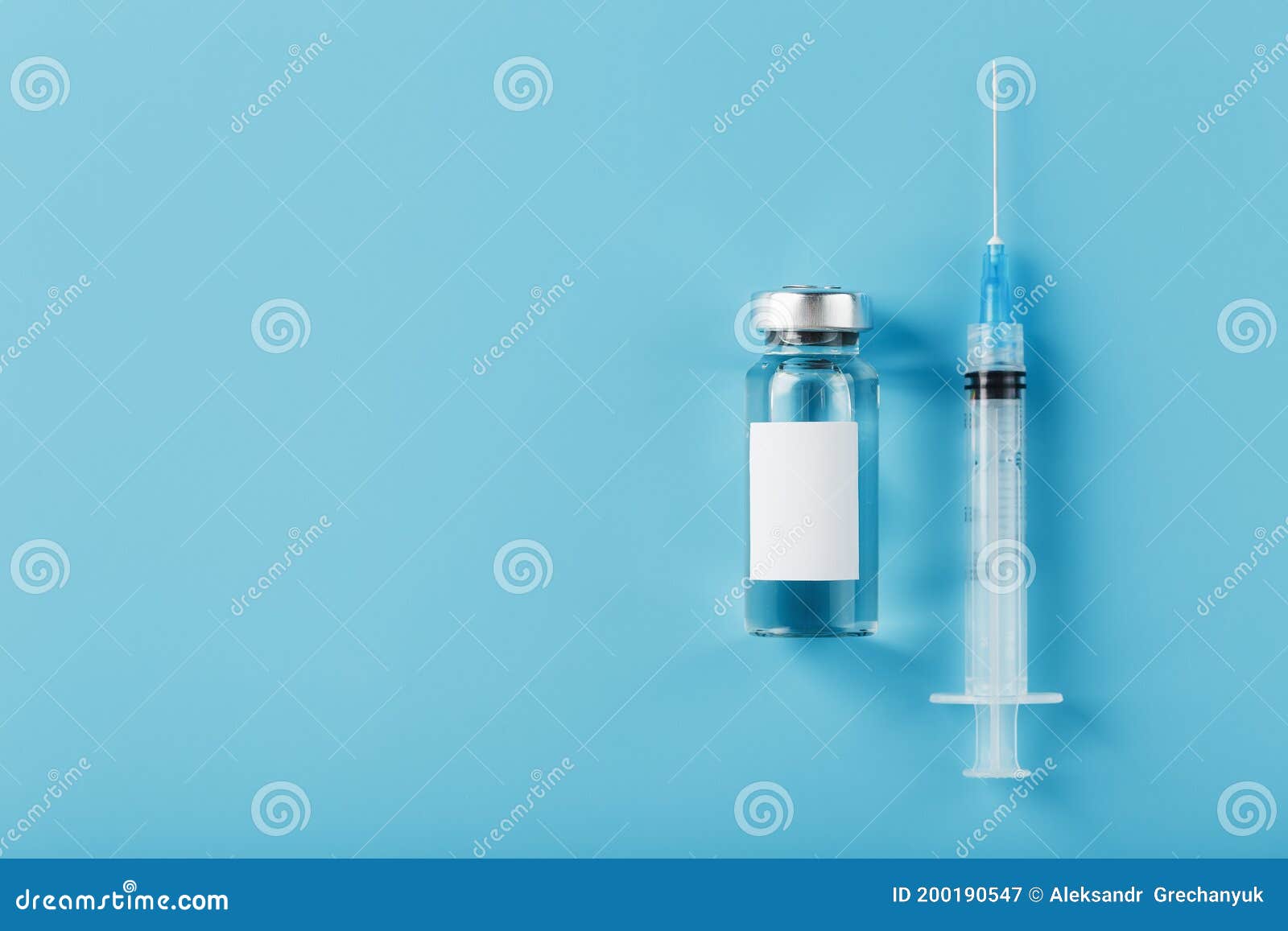 ampoule with a vaccine and a syringe for viruses and diseases on a blue background