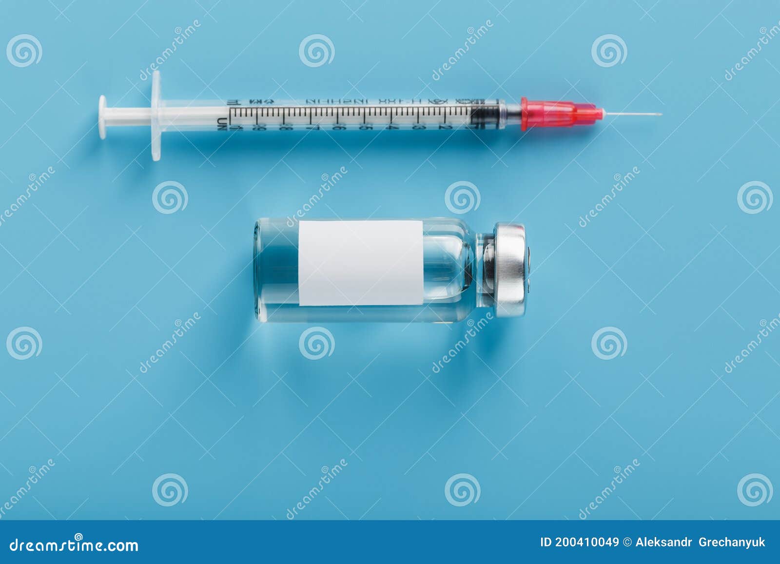 ampoule with a vaccine and a syringe for viruses and diseases on a blue background