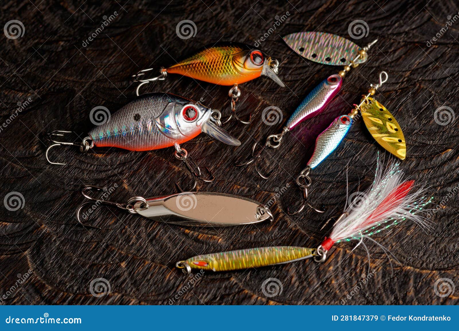 Set of Metal and Plastic Lures for Fishing on Dark Oak Stock Image