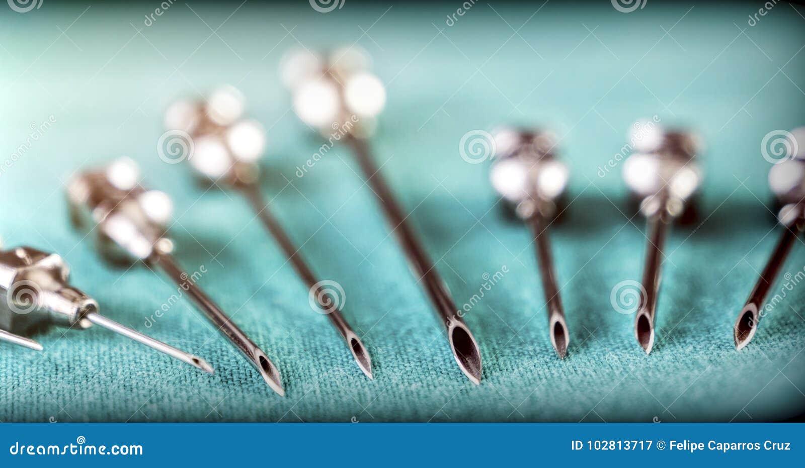 Set of Metallic Needles of Different Size Along with Syringe on Operations Table Stock Image
