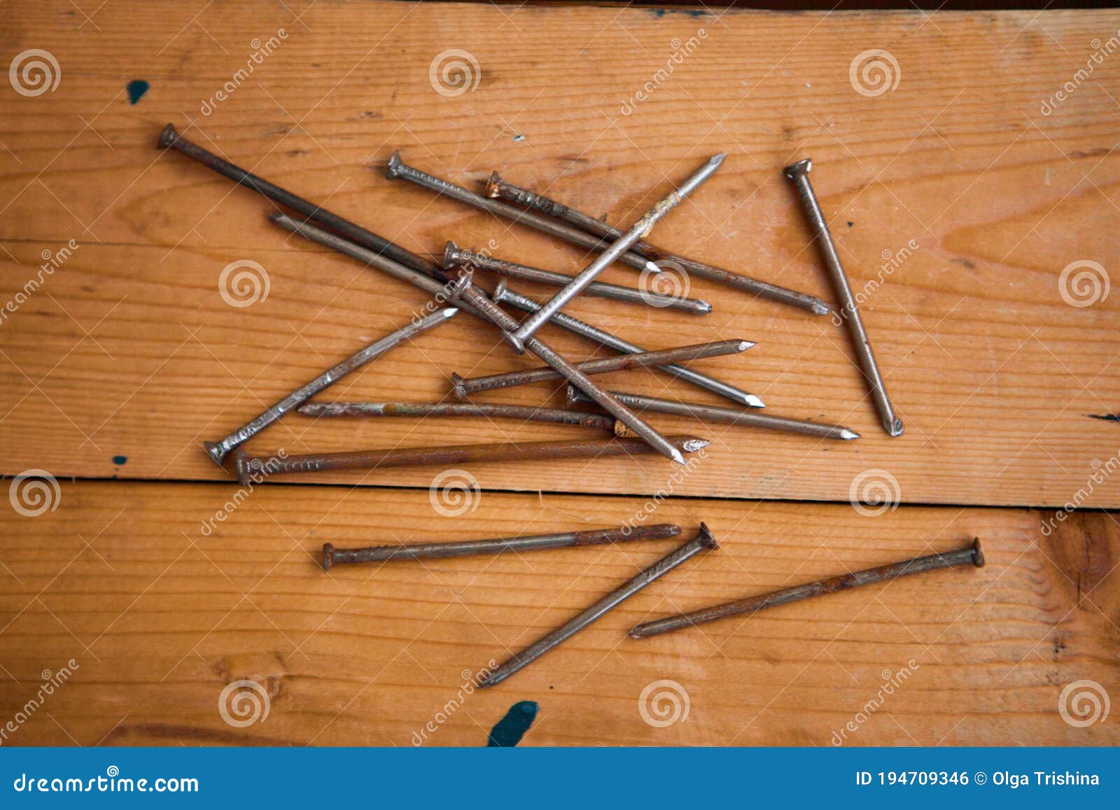 set of metalware, rusty nails on the wooden background