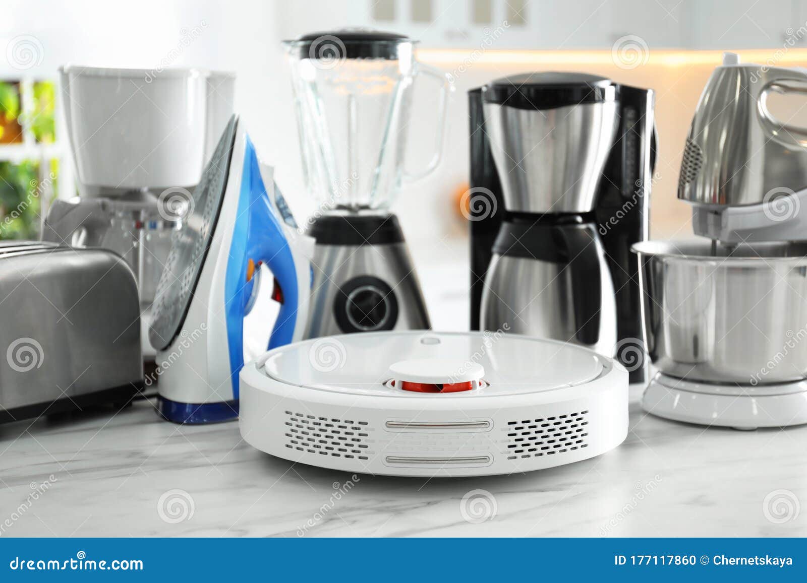 Set of Home Appliances in Kitchen, Focus on Robotic Vacuum Cleaner