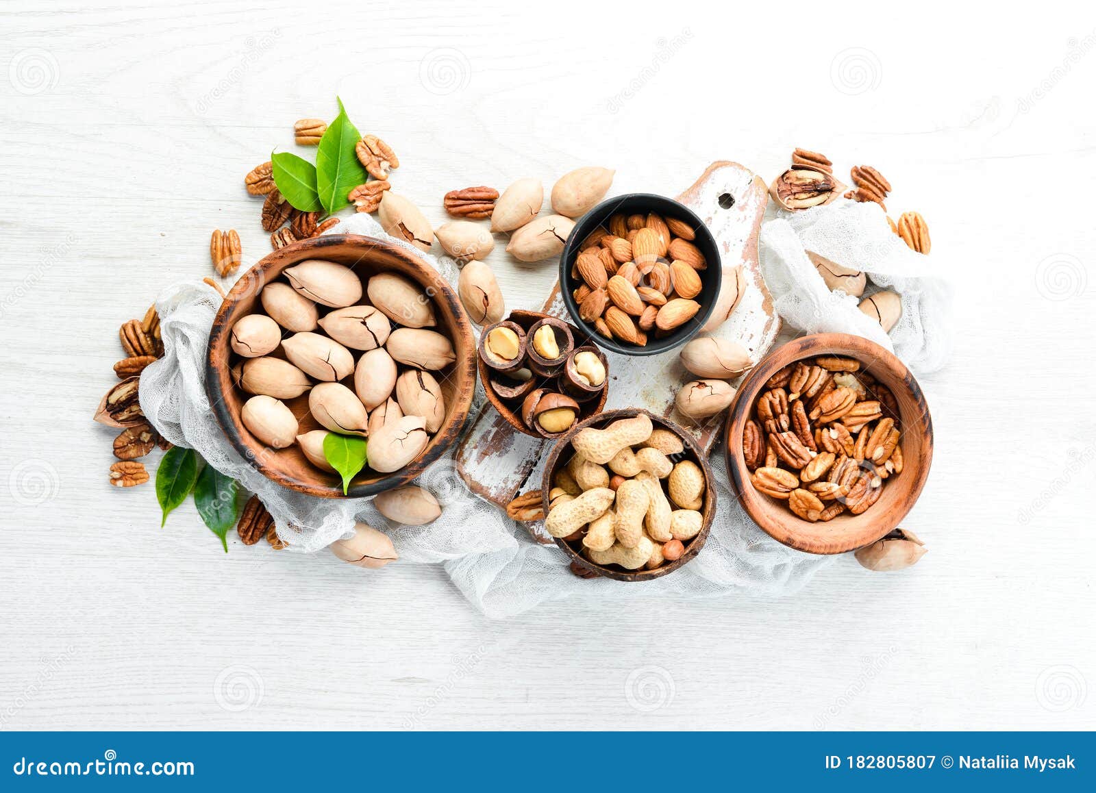 Set of Nuts. Pecans and Macadamia Nuts in Bowls on a White Background