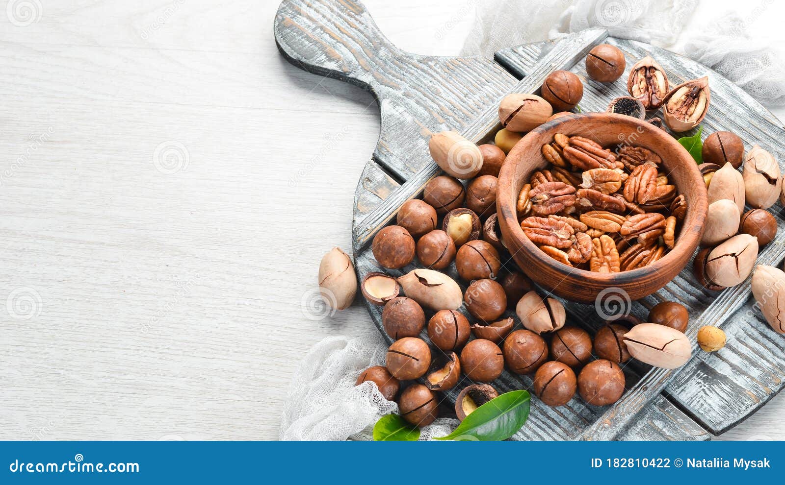Set of Nuts. Pecans and Macadamia Nuts in Bowls on a White Background