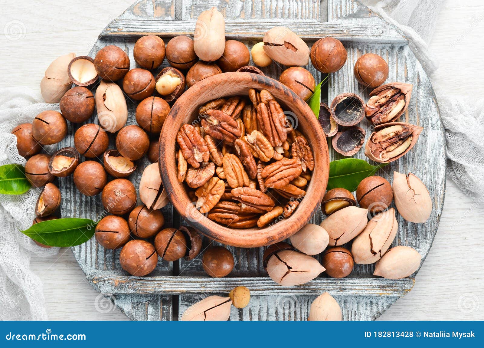 Set of Nuts. Pecans and Macadamia Nuts in Bowls on a White Background