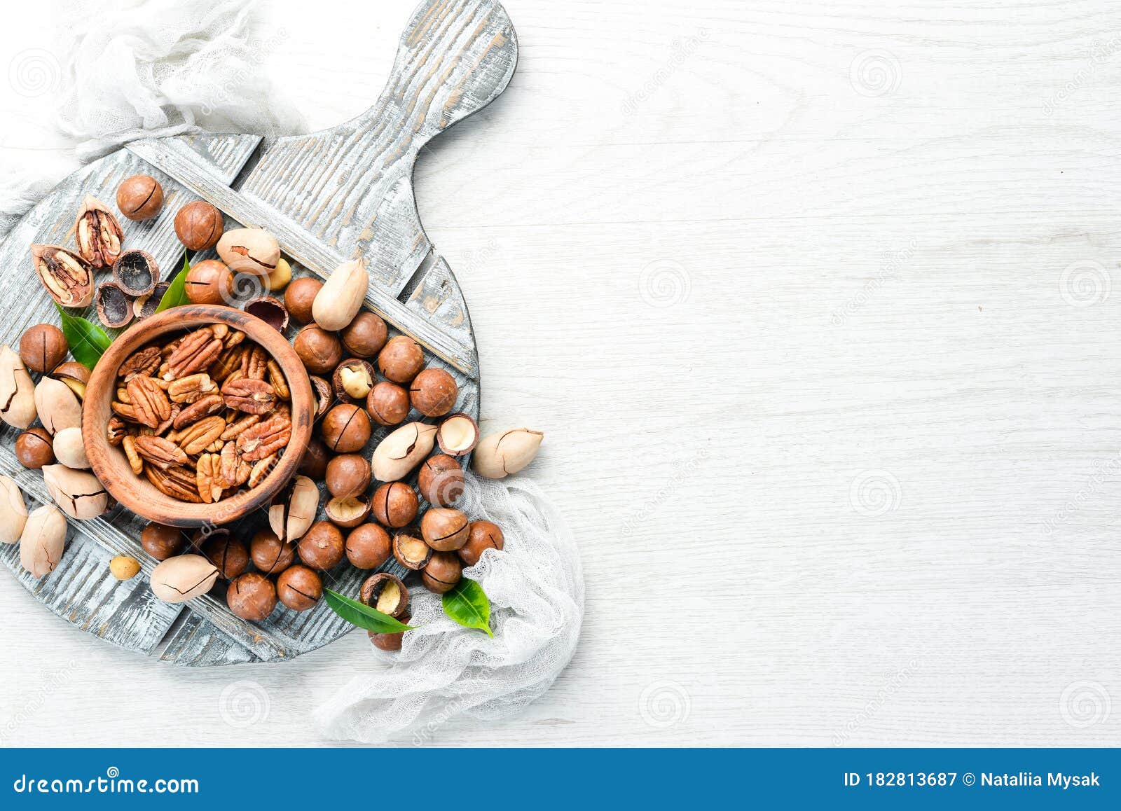 Set of Nuts. Pecans and Macadamia Nuts in Bowls on a White Background