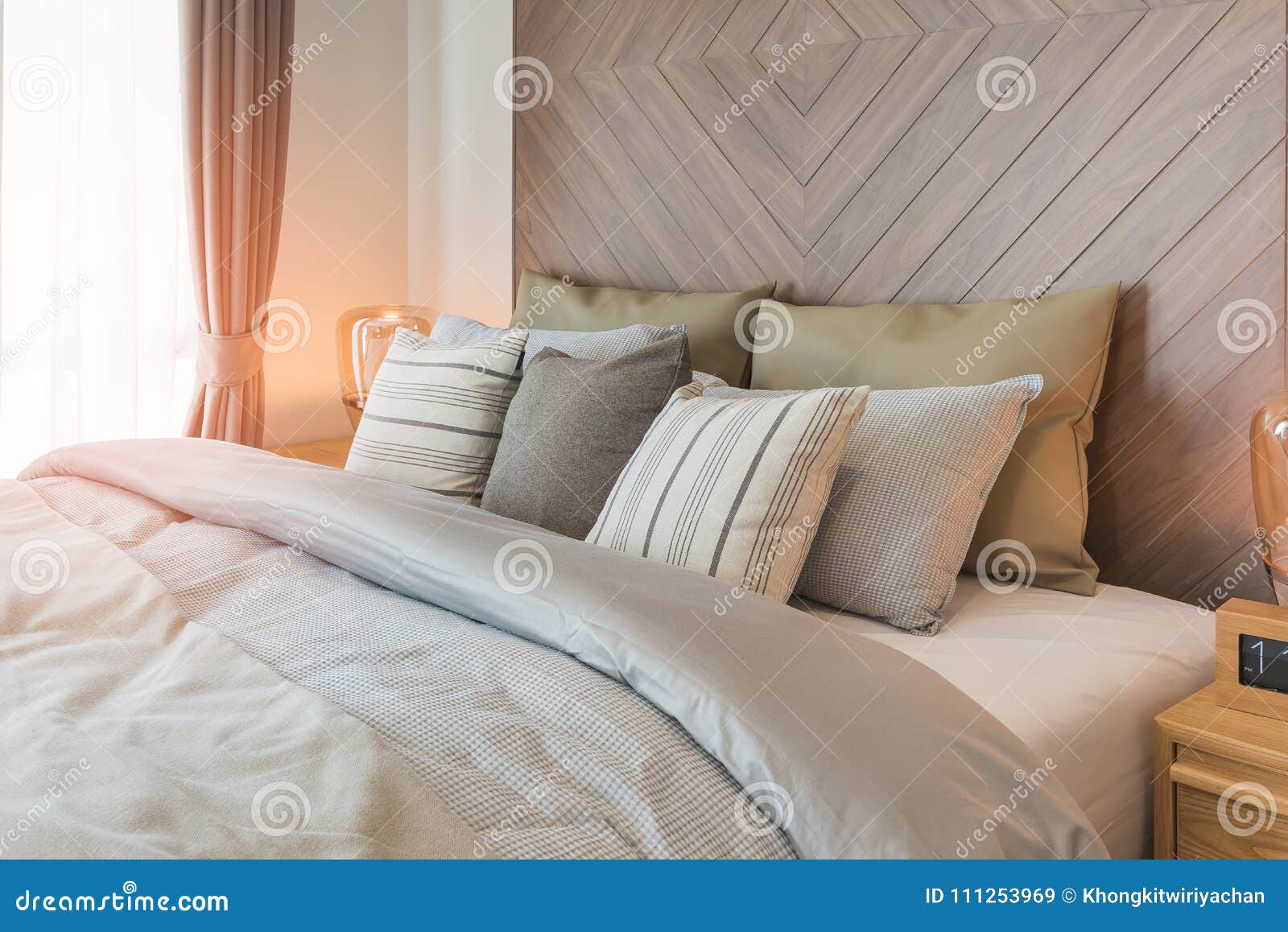 Set of Pillows on Bed with Wooden Wall Stock Image - Image of luxury ...