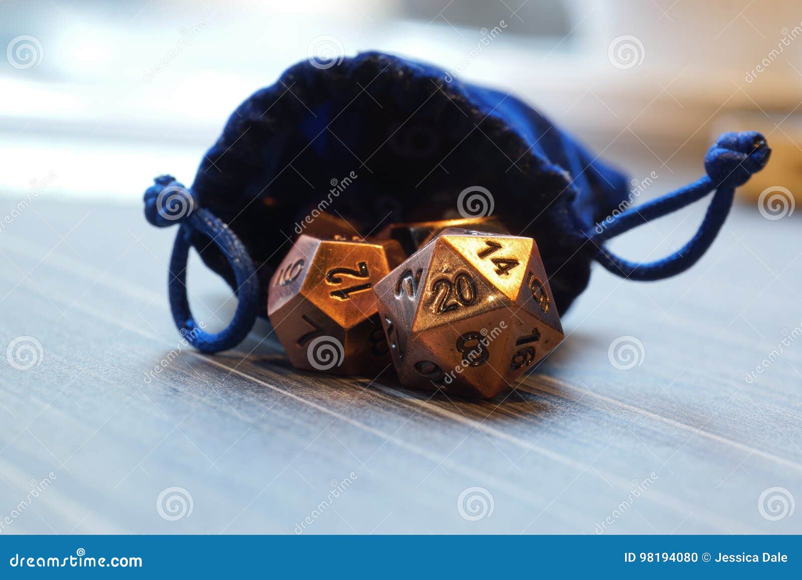 a set of polyhedral dice with a draw string bag