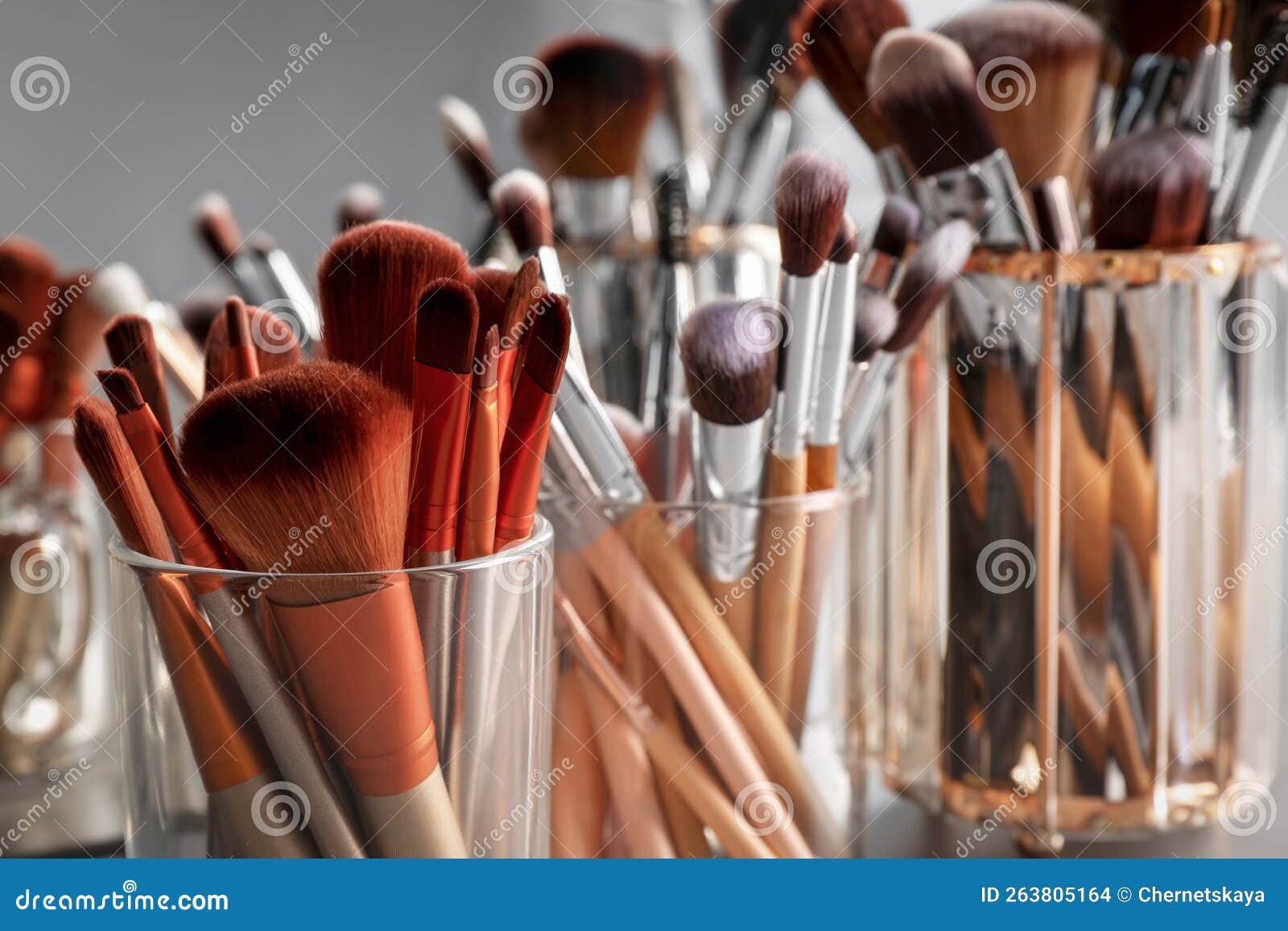 Set of Professional Makeup Brushes Near Mirror, Closeup Stock Photo