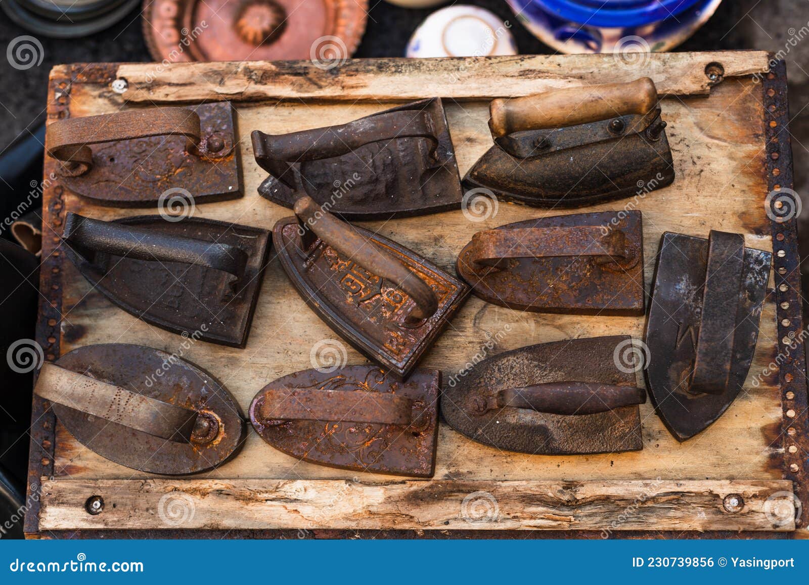 Set of Rusty Cast Iron and Steel Irons on a Flea Market Stock Photo