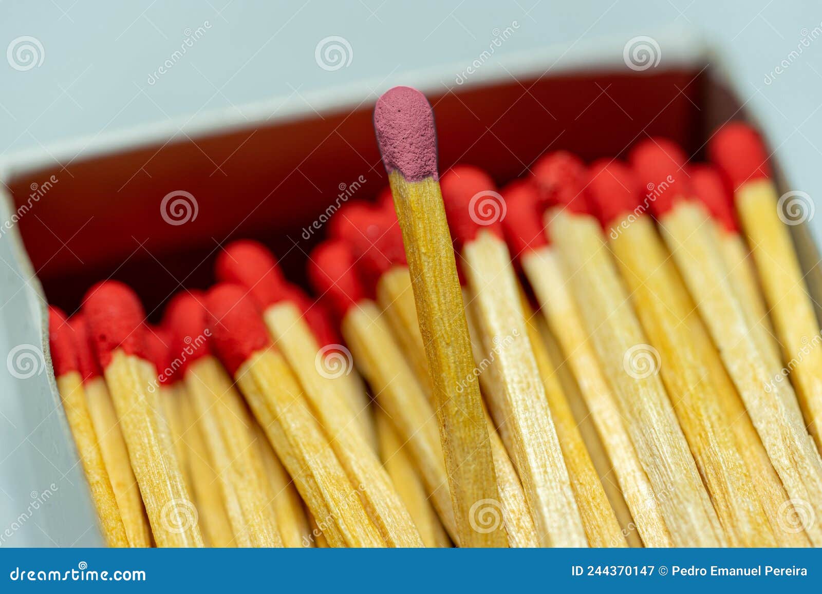 set of several defocused red-headed matchsticks with one pink-headed matchstick in evidence.