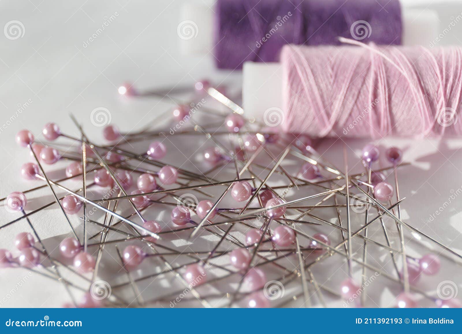 Set of Sewing Decorative Pins. Stack of Needles with Rose Colored Heads